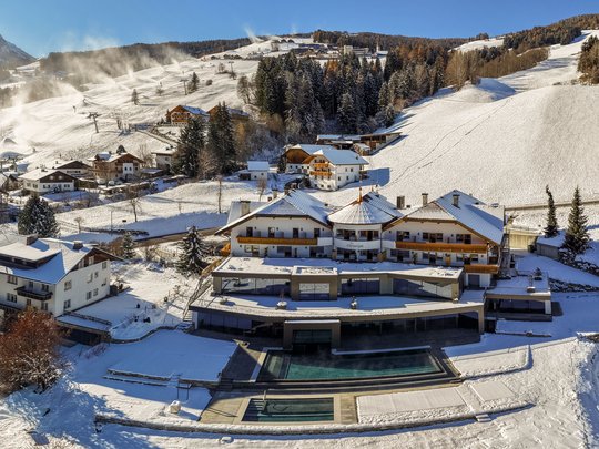 Your Plan de Corones/Kronplatz hotel on the slopes Hotel in snowy mountain landscape with ski area and forest
