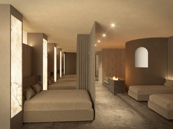 A warm welcome to our hotel in Olang, at Plan de Corones/Kronplatz Modern bedroom with warm lighting and multiple beds separated by partitions