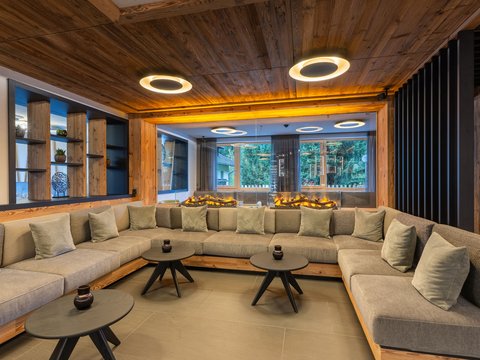 Around our hotel on the piste in Plan de Corones/Kronplatz Modern living room with gray corner sofa and round wooden side tables