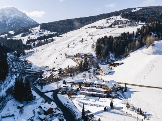 Your Plan de Corones/Kronplatz hotel on the slopes Snow-covered mountain landscape with ski resort and houses in winter