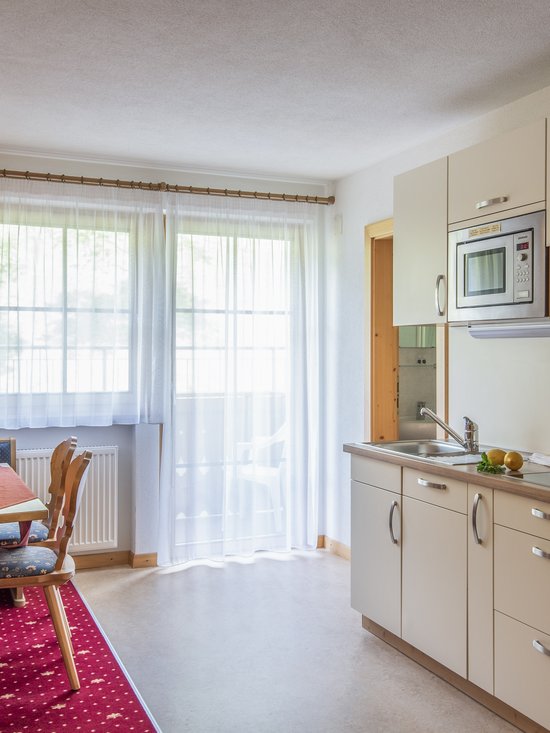 4-Sterne-Hotel am Kronplatz: Ihr perfektes Urlaubszuhause Helle Küche mit Essbereich und moderner Ausstattung